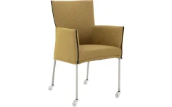 Goossens Eetkamerstoel Funk RVS Poten groen stof met armleuning en met wielenTransparant skater wiel met rvs kap, modern design