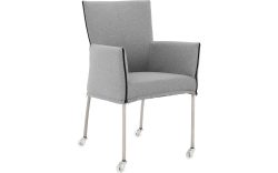 Goossens Eetkamerstoel Funk RVS Poten grijs stof met armleuning en met wielenTransparant skater wiel met rvs kap, modern design